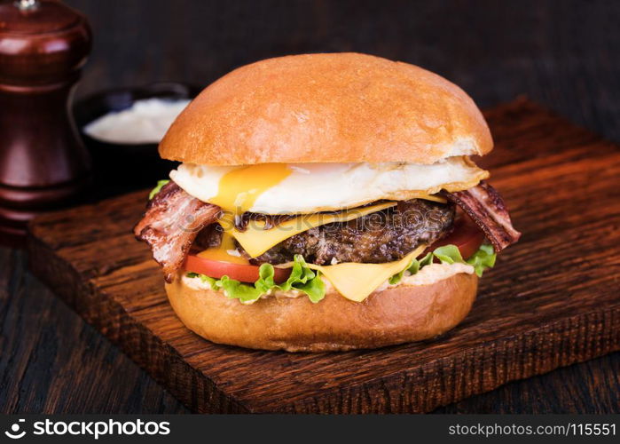 burger. homemade grilled burger on wooden board