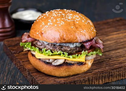 Burger on a wooden board. fresh tasty burger on wood table