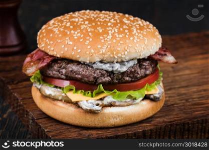 Burger on a wooden board. fresh tasty burger on wood table