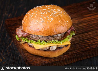 Burger on a wooden board. fresh tasty burger on wood table