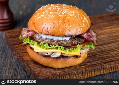 Burger on a wooden board. fresh tasty burger on wood table