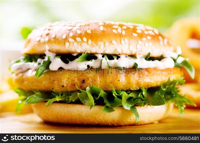 burger with chicken on wooden table