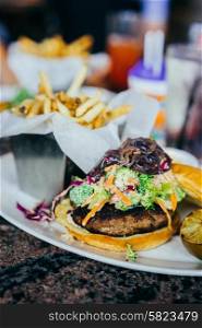 Burger with coleslaw and french fries