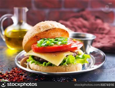 burger with cutlet and cheese on a table