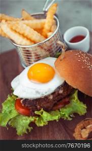 Burger with french fries, traditional american food, unhealthy nutrition