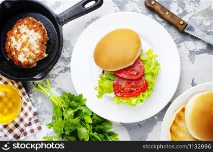 burgers with chicken cutlets on white plate