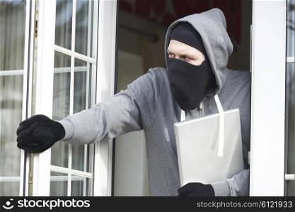Burglar Breaking Into House And Stealing Laptop Computer