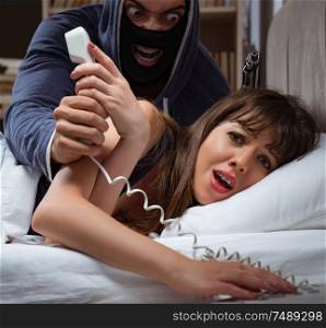 Burglar breaking into house at night to bedroom with sleeping woman. Burglar breaking into house at night to bedroom with sleeping wo