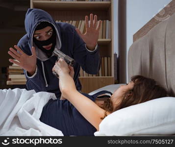 Burglar breaking into house at night to bedroom with sleeping woman. Burglar breaking into house at night to bedroom with sleeping wo