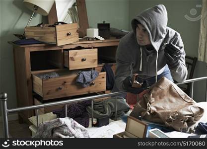 Burglar Stealing Items From Bedroom During Hose Break In