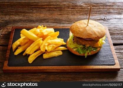 Burguer and french fries potato chips on wood table