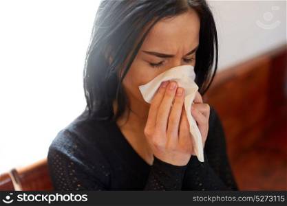 burial, people, grief and mourning concept - close up of unhappy crying woman blowing nose with wipe at funeral day. crying woman blowing nose with wipe at funeral day