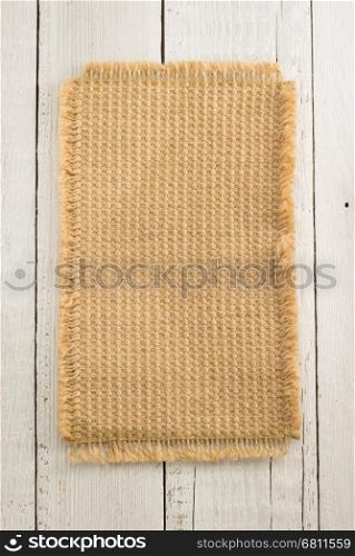 burlap hessian sack on wooden background