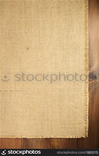 burlap hessian sacking backdrop on wooden background