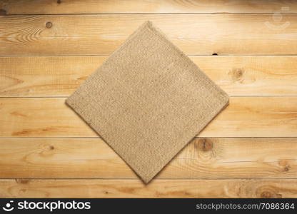 burlap hessian sacking cloth on wooden background table, top view