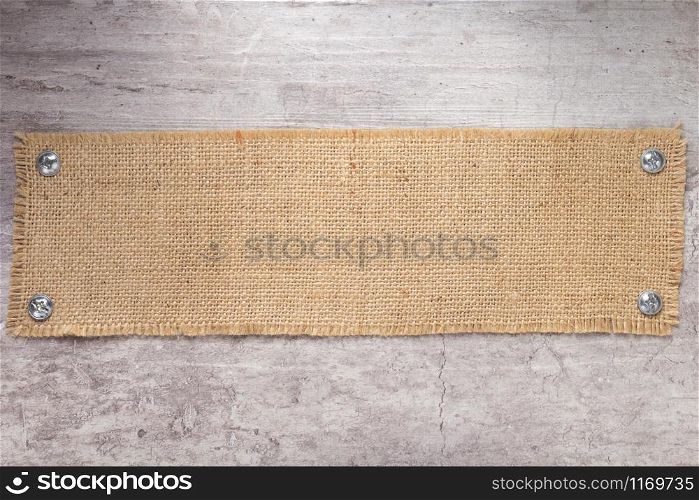burlap hessian sacking texture at stone wall surface as background texture