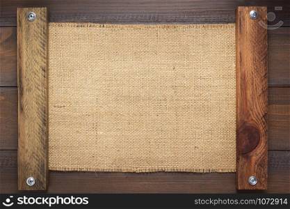 burlap hessian sacking texture on wooden background