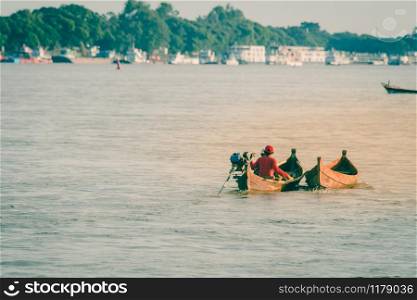 Burmese fishing boat on the River with Grass tree background in Mingun,Mandalay, Myanmar (Burma)