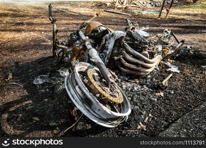 Burned motorcycle after an accident lying down. Burned motorcycle after an accident