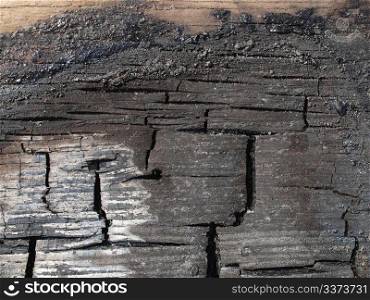 Burned wood. Ashes of burned wood plank board damaged by of fire