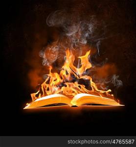 Burning book. Image of opened burning book against black background