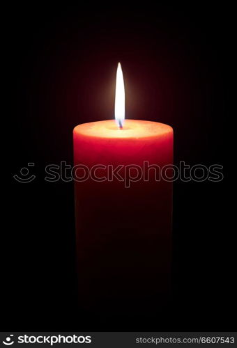 Burning candle isolated on black