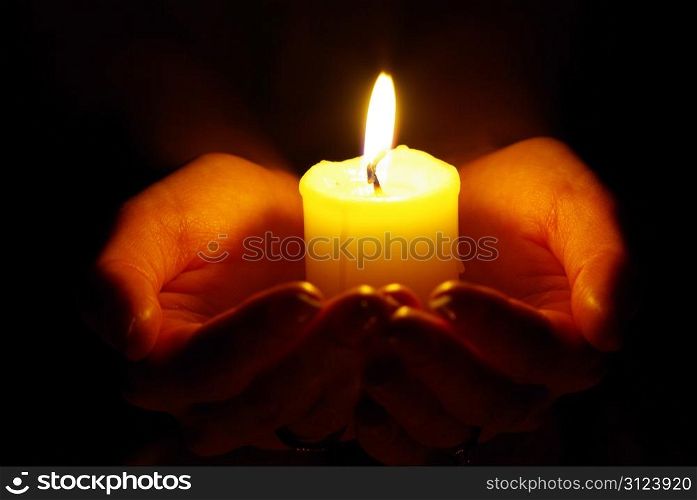 burning candle on a black background