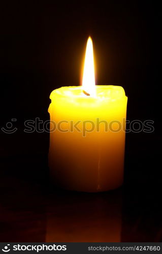 burning candle on a black background