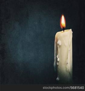 Burning candle over black. Is not isolated, just shot on black