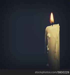 Burning candle over dark backgrounds