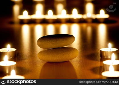 Burning candles and pebbles for aromatherapy session