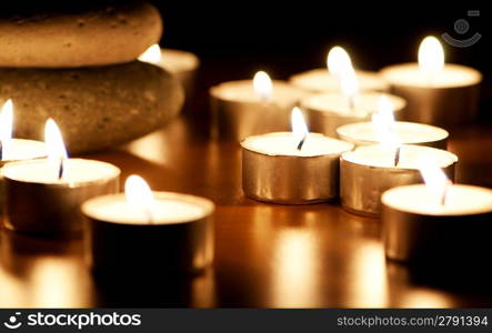 Burning candles and pebbles for aromatherapy session