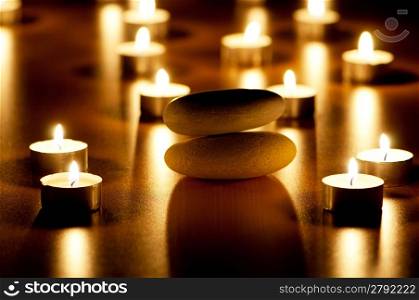 Burning candles and pebbles for aromatherapy session