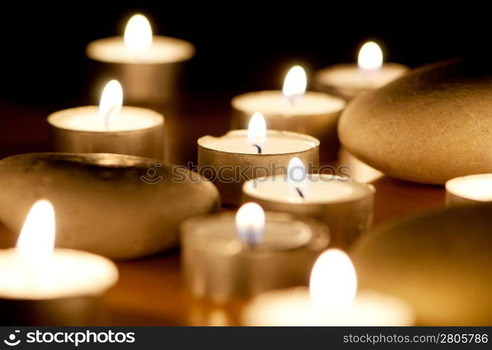 Burning candles and pebbles for aromatherapy session