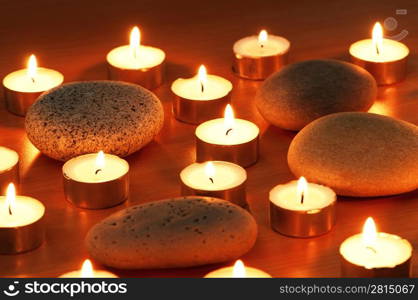 Burning candles and pebbles for aromatherapy session