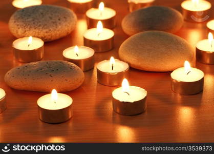 Burning candles and pebbles for aromatherapy session