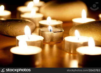 Burning candles and pebbles for aromatherapy session