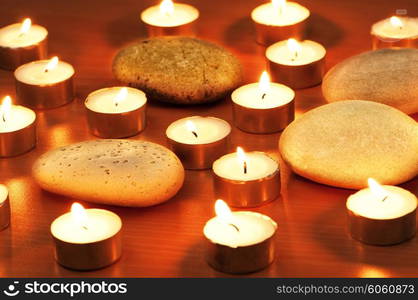 Burning candles and pebbles for aromatherapy session