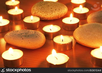 Burning candles and pebbles for aromatherapy session