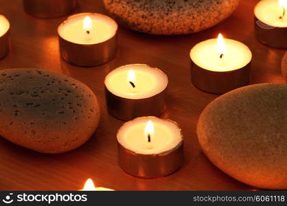 Burning candles and pebbles for aromatherapy session