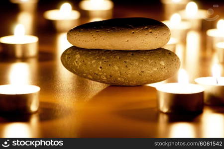 Burning candles and pebbles for aromatherapy session