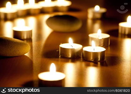 Burning candles and pebbles for aromatherapy session