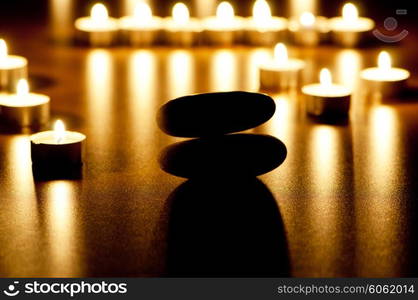 Burning candles and pebbles for aromatherapy session