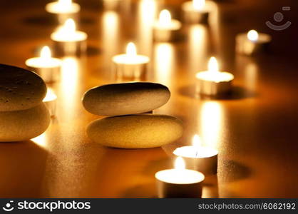 Burning candles and pebbles for aromatherapy session