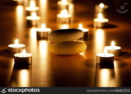 Burning candles and pebbles for aromatherapy session