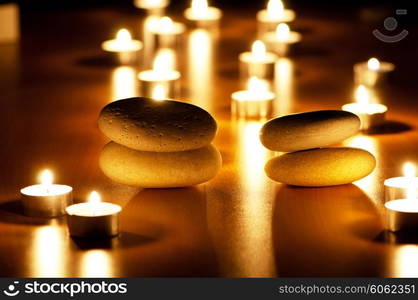 Burning candles and pebbles for aromatherapy session