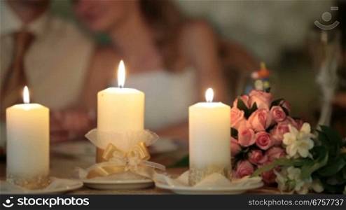 burning candles at the wedding table in the restaurant