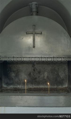 Burning candles in a church. Day light. Greece