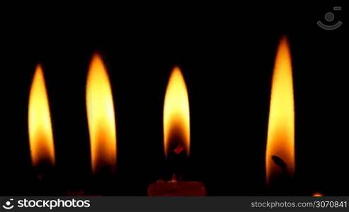 Burning candles isolated on black background