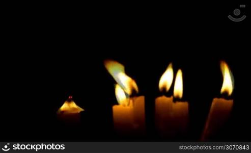 Burning candles isolated on black background